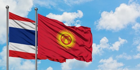 Thailand and Kyrgyzstan flag waving in the wind against white cloudy blue sky together. Diplomacy concept, international relations.