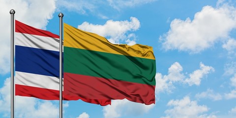 Thailand and Lithuania flag waving in the wind against white cloudy blue sky together. Diplomacy concept, international relations.