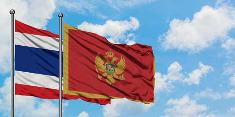 Thailand and Montenegro flag waving in the wind against white cloudy blue sky together. Diplomacy concept, international relations.
