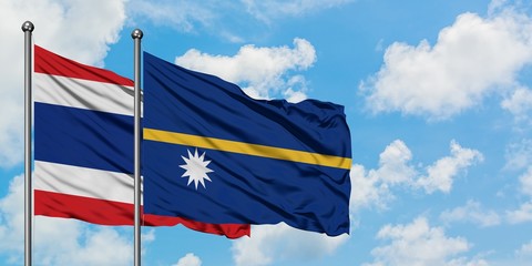 Thailand and Nauru flag waving in the wind against white cloudy blue sky together. Diplomacy concept, international relations.