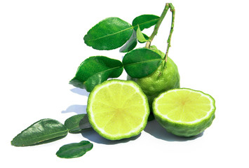 Kaffir lime fruit with green leaves isolated on white background. Cut Leech lime or Bergamot with leaf isolated