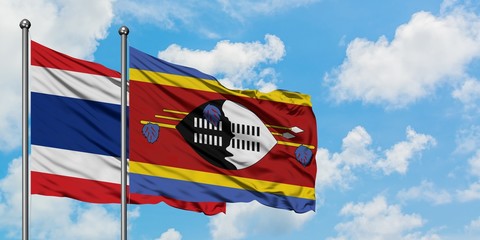 Thailand and Swaziland flag waving in the wind against white cloudy blue sky together. Diplomacy concept, international relations.