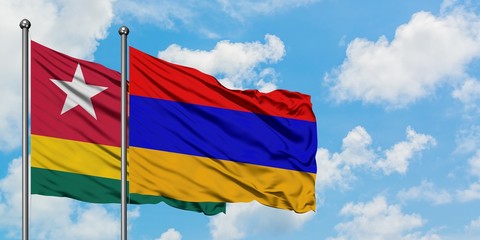 Togo and Armenia flag waving in the wind against white cloudy blue sky together. Diplomacy concept, international relations.