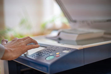 copying a book on a copy machine for study in a library