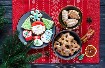 Homemade gingerbreads on plate on wooden background. Holidays and celebration concept, greeting card mockup, festive decoration. Christmas and New Year composition.