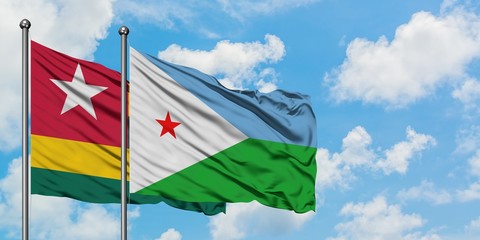 Togo and Djibouti flag waving in the wind against white cloudy blue sky together. Diplomacy concept, international relations.