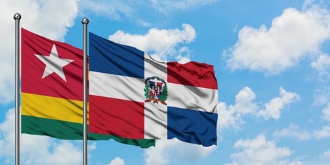 Togo and Dominican Republic flag waving in the wind against white cloudy blue sky together. Diplomacy concept, international relations.