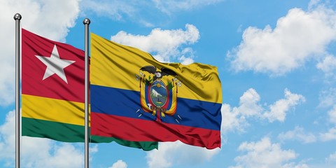 Togo and Ecuador flag waving in the wind against white cloudy blue sky together. Diplomacy concept, international relations.