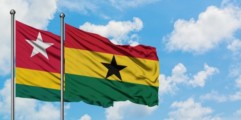 Togo and Ghana flag waving in the wind against white cloudy blue sky together. Diplomacy concept, international relations.