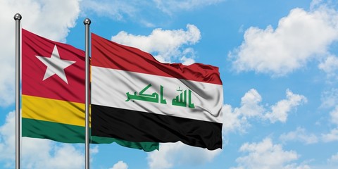 Togo and Iraq flag waving in the wind against white cloudy blue sky together. Diplomacy concept, international relations.