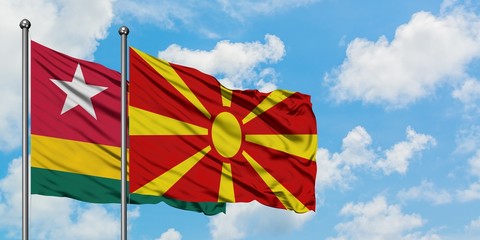 Togo and Macedonia flag waving in the wind against white cloudy blue sky together. Diplomacy concept, international relations.