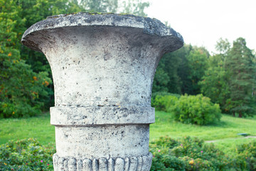 Fototapeta na wymiar old antique vase outside in green park, landscape view
