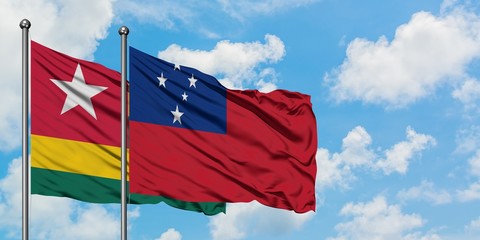 Togo and Samoa flag waving in the wind against white cloudy blue sky together. Diplomacy concept, international relations.