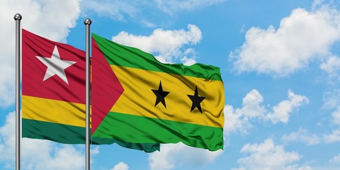 Togo and Sao Tome And Principe flag waving in the wind against white cloudy blue sky together. Diplomacy concept, international relations.