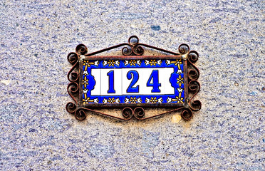 Number 124, one hundred and four, beautiful tiles in steel floral frame.