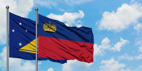Tokelau and Liechtenstein flag waving in the wind against white cloudy blue sky together. Diplomacy concept, international relations.