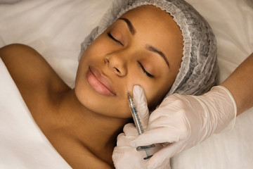 Injection cosmetology: contour plastic. Doctor makes rejuvenating facial injections procedure....