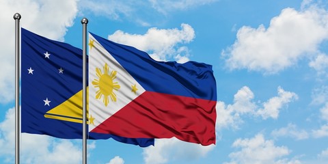 Tokelau and Philippines flag waving in the wind against white cloudy blue sky together. Diplomacy concept, international relations.