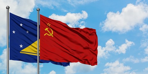 Tokelau and Soviet Union flag waving in the wind against white cloudy blue sky together. Diplomacy concept, international relations.