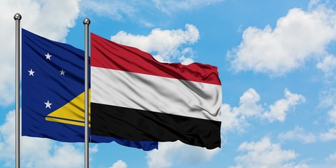 Tokelau and Yemen flag waving in the wind against white cloudy blue sky together. Diplomacy concept, international relations.