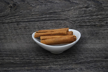 Cinnamon Stick in a dish on a rustic background