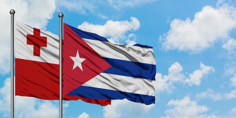 Tonga and Cuba flag waving in the wind against white cloudy blue sky together. Diplomacy concept, international relations.