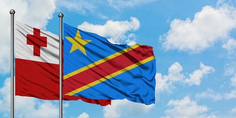 Tonga and Congo flag waving in the wind against white cloudy blue sky together. Diplomacy concept, international relations.