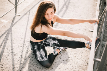 Beautiful sport fitness girl in sportswear doing fitness exercise in the street ,outdoor sports. Urban style.