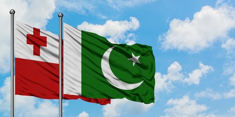 Tonga and Pakistan flag waving in the wind against white cloudy blue sky together. Diplomacy concept, international relations.