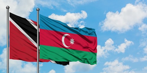 Trinidad And Tobago and Azerbaijan flag waving in the wind against white cloudy blue sky together. Diplomacy concept, international relations.