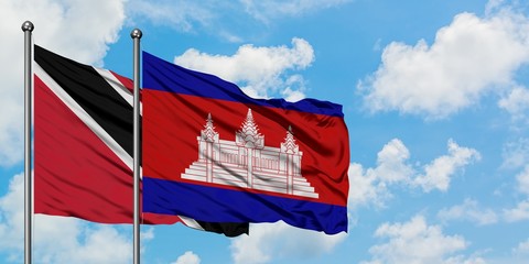 Trinidad And Tobago and Cambodia flag waving in the wind against white cloudy blue sky together....