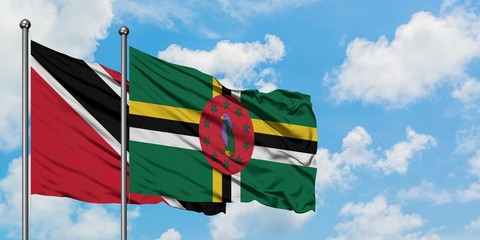 Trinidad And Tobago and Dominica flag waving in the wind against white cloudy blue sky together. Diplomacy concept, international relations.