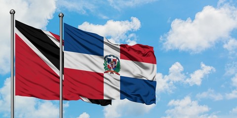 Trinidad And Tobago and Dominican Republic flag waving in the wind against white cloudy blue sky together. Diplomacy concept, international relations.