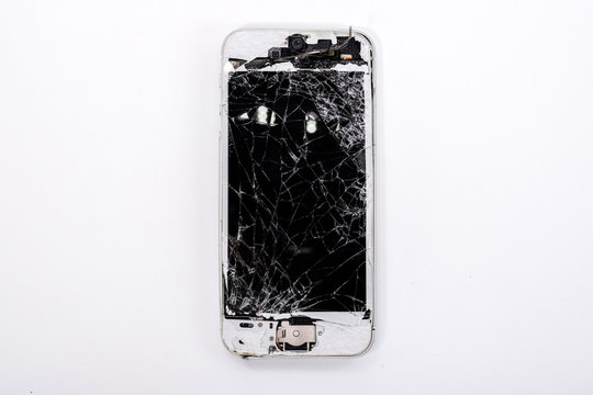 Studio shot of broken Smartphone with seriously broken retina Phone display screen Isolated on white