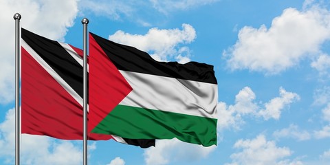 Trinidad And Tobago and Palestine flag waving in the wind against white cloudy blue sky together. Diplomacy concept, international relations.