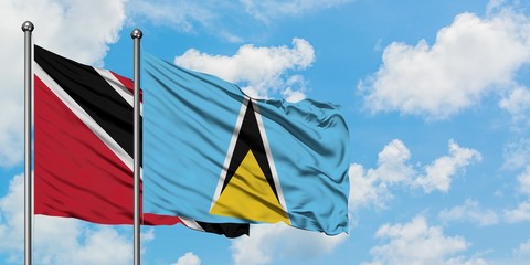 Trinidad And Tobago and Saint Lucia flag waving in the wind against white cloudy blue sky together. Diplomacy concept, international relations.