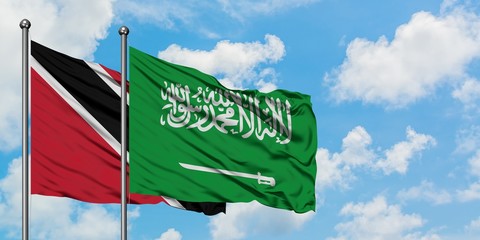 Trinidad And Tobago and Saudi Arabia flag waving in the wind against white cloudy blue sky together. Diplomacy concept, international relations.