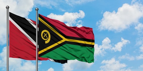 Trinidad And Tobago and Vanuatu flag waving in the wind against white cloudy blue sky together. Diplomacy concept, international relations.