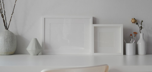 Minimal office room with mock up frames and white ceramic vase decorations