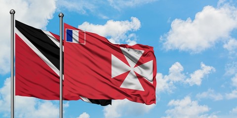 Trinidad And Tobago and Wallis And Futuna flag waving in the wind against white cloudy blue sky...