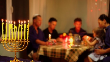 Jewish family eating together festive kosher meals. Hanukkah night. Jewish Holidays and Food....