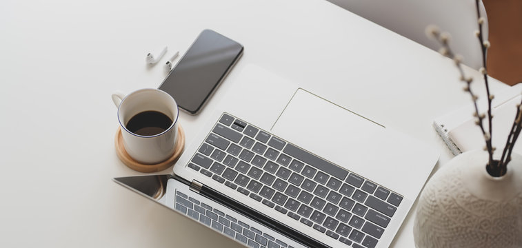 Close-up view of modern workspace with laptop computer and office supplies
