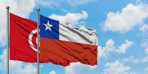 Tunisia and Chile flag waving in the wind against white cloudy blue sky together. Diplomacy concept, international relations.