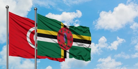 Tunisia and Dominica flag waving in the wind against white cloudy blue sky together. Diplomacy concept, international relations.