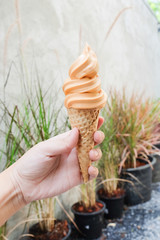 Thai milk tea flavor soft serve ice cream in crispy cone