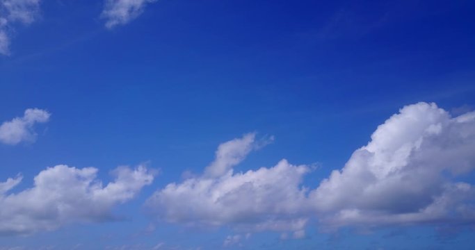 White clouds moving slowly in beautiful blue sky - Wide shots