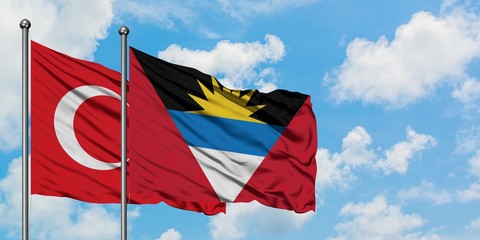 Turkey and Antigua and Barbuda flag waving in the wind against white cloudy blue sky together....