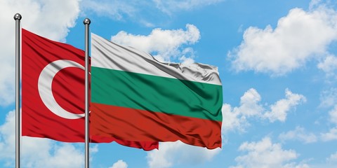 Turkey and Bulgaria flag waving in the wind against white cloudy blue sky together. Diplomacy concept, international relations.