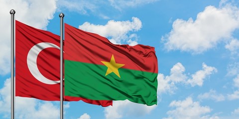 Turkey and Burkina Faso flag waving in the wind against white cloudy blue sky together. Diplomacy...