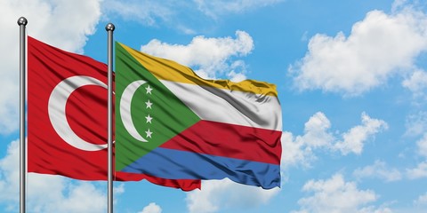 Turkey and Comoros flag waving in the wind against white cloudy blue sky together. Diplomacy...